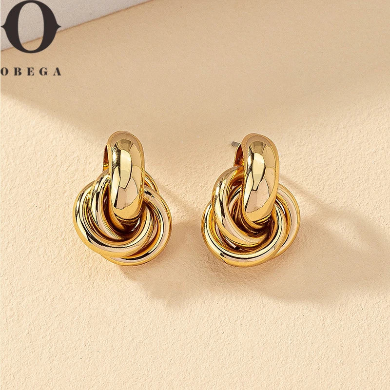 Pendientes de aro con nudo Obega en color dorado y plateado para mujer con baño brillante