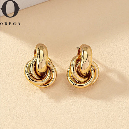 Pendientes de aro con nudo Obega en color dorado y plateado para mujer con baño brillante
